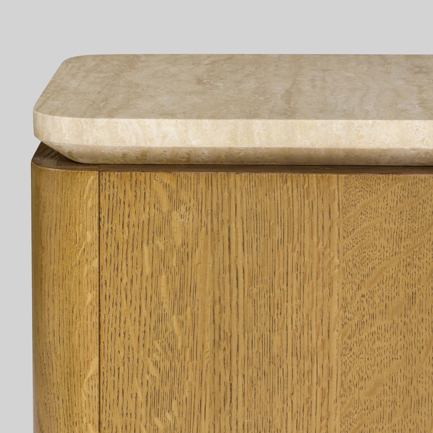 Wooden side table with a light finish and travertine top on a gray background.