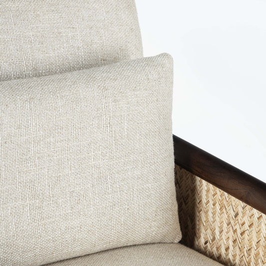 Beige armchair with cane arms and wooden frame on a light gray background.