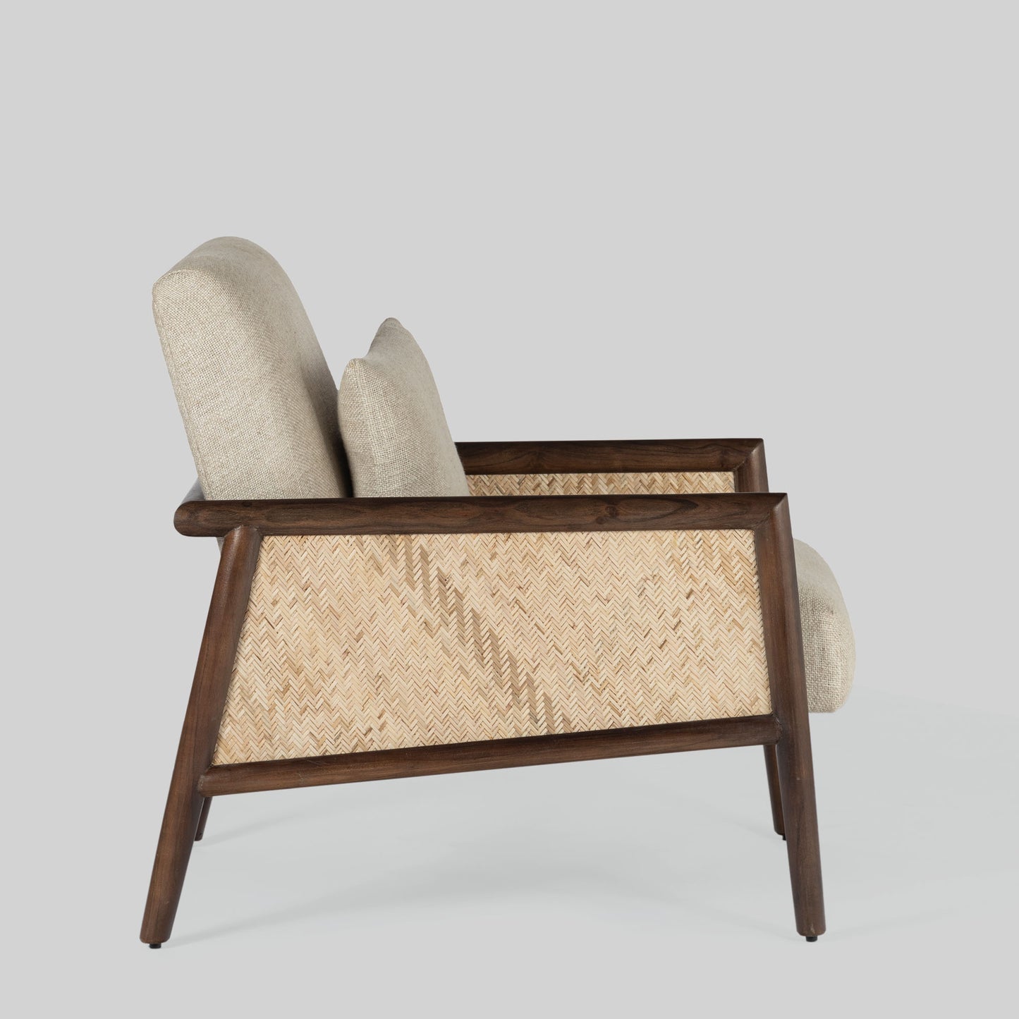 Beige armchair with cane arms and wooden frame on a light gray background.