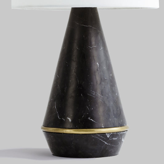 Modern honed black marble table lamp, closeup of marble base.