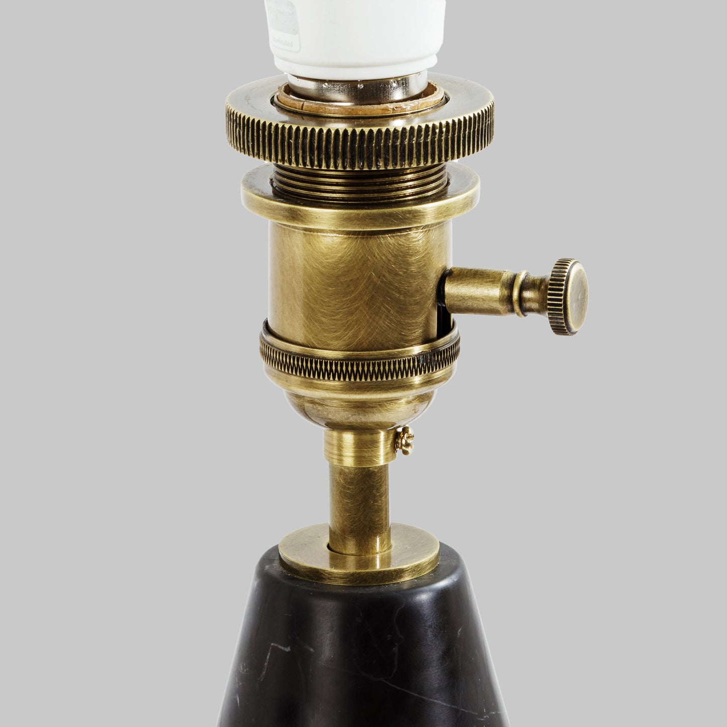 Modern honed black marble table lamp, closeup view of hardware.