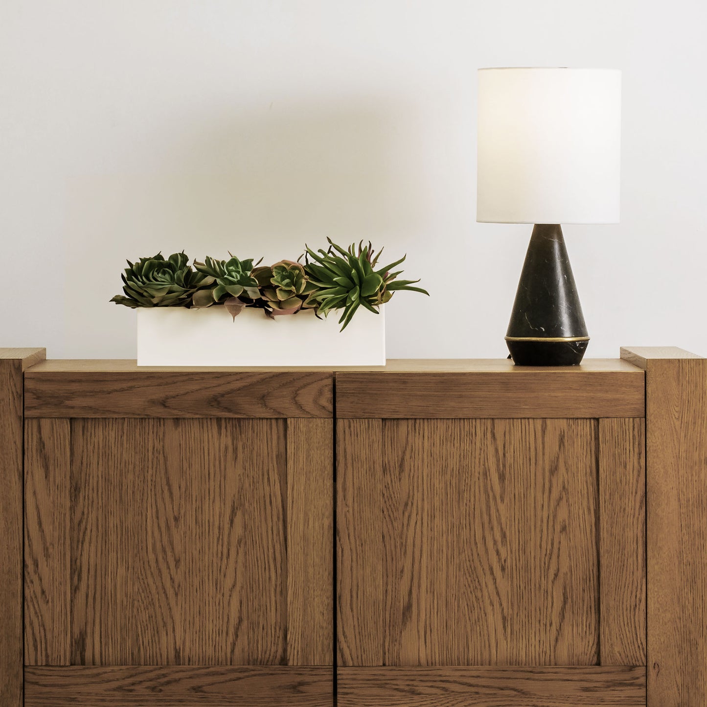 Modern honed black marble table lamp stylized on console table.