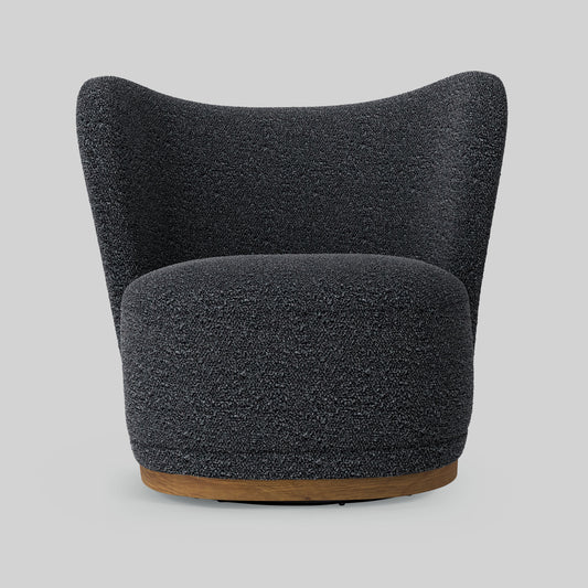Dark gray boucle fabric lounge chair on gray background.
