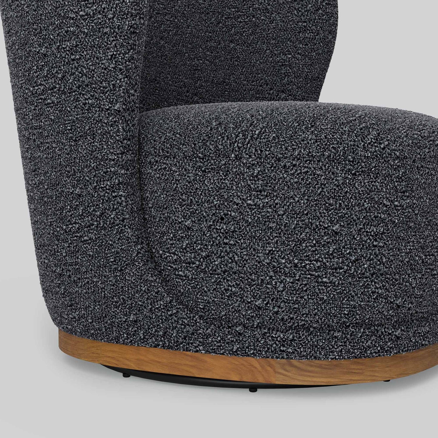 Dark gray boucle fabric lounge chair on gray background.