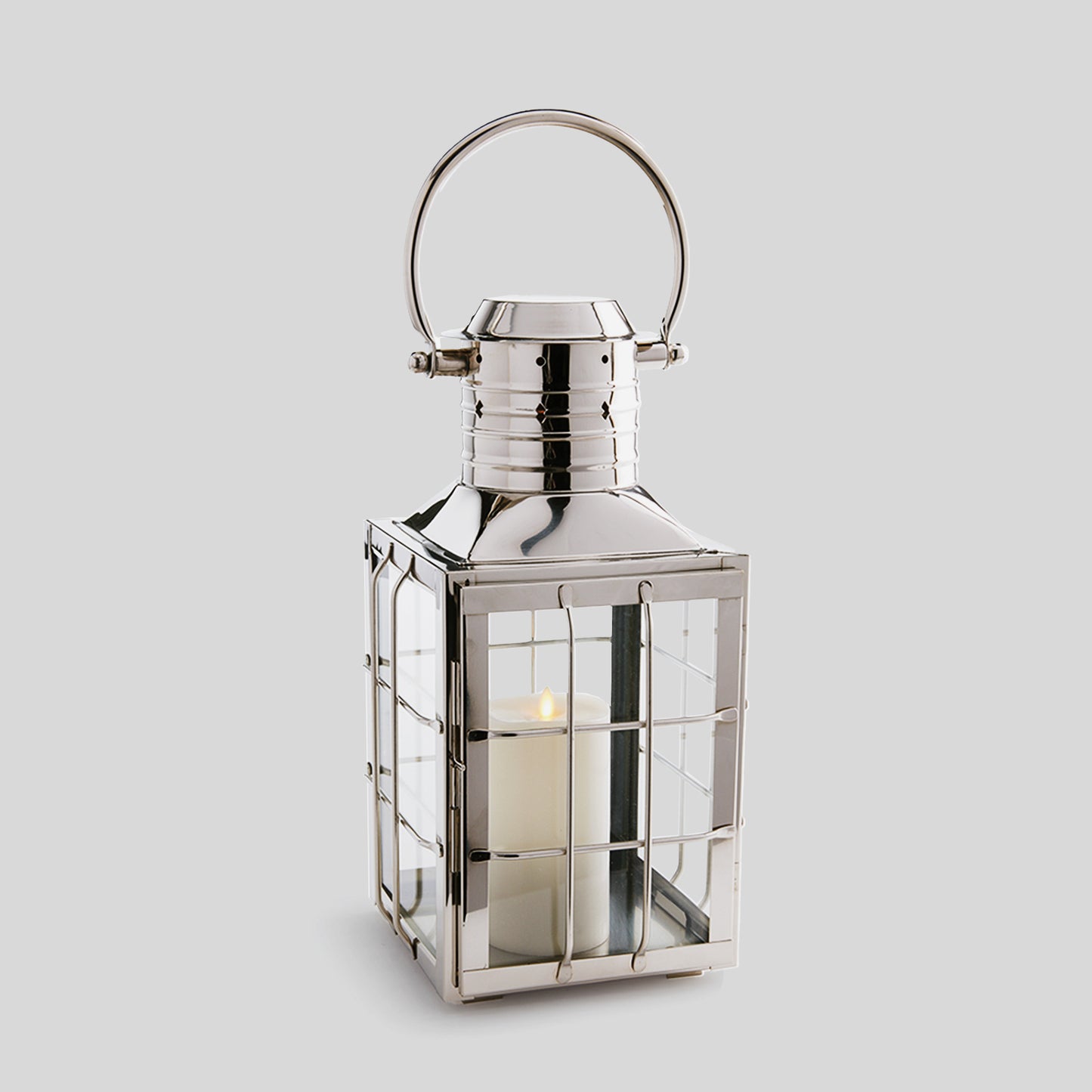 Nautical polished metal outdoor lantern in large size with gray background.