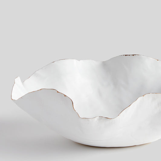 Organic decorative ceramic large bowl, closeup view, with gray background.