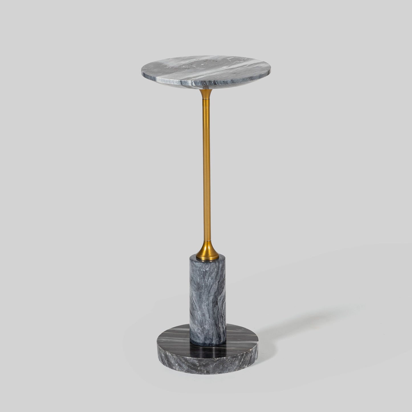 Small round cocktail table with marble top and brass base on a light gray background.