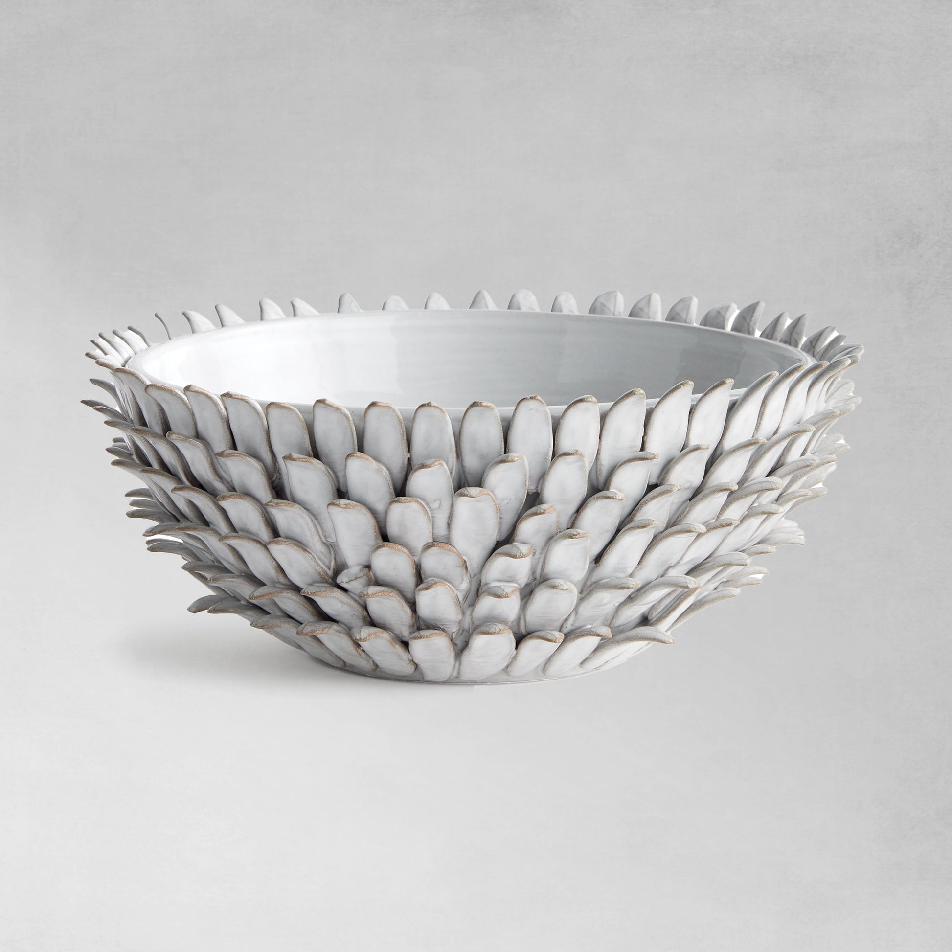 Petal decorative terracotta bowl with gray background.