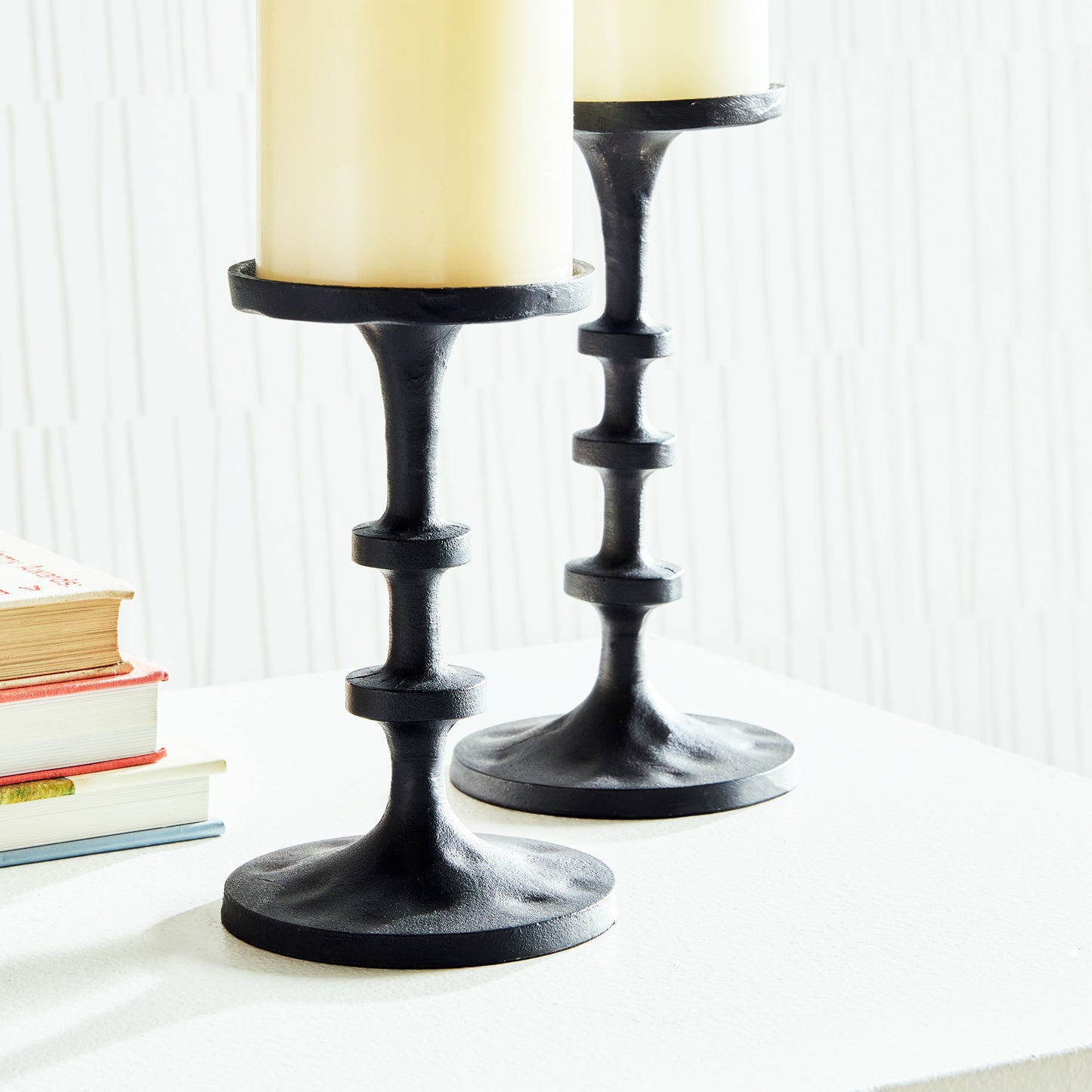 Petite minimalist pillar candleholders, set of 2, in black bronze, closeup view.