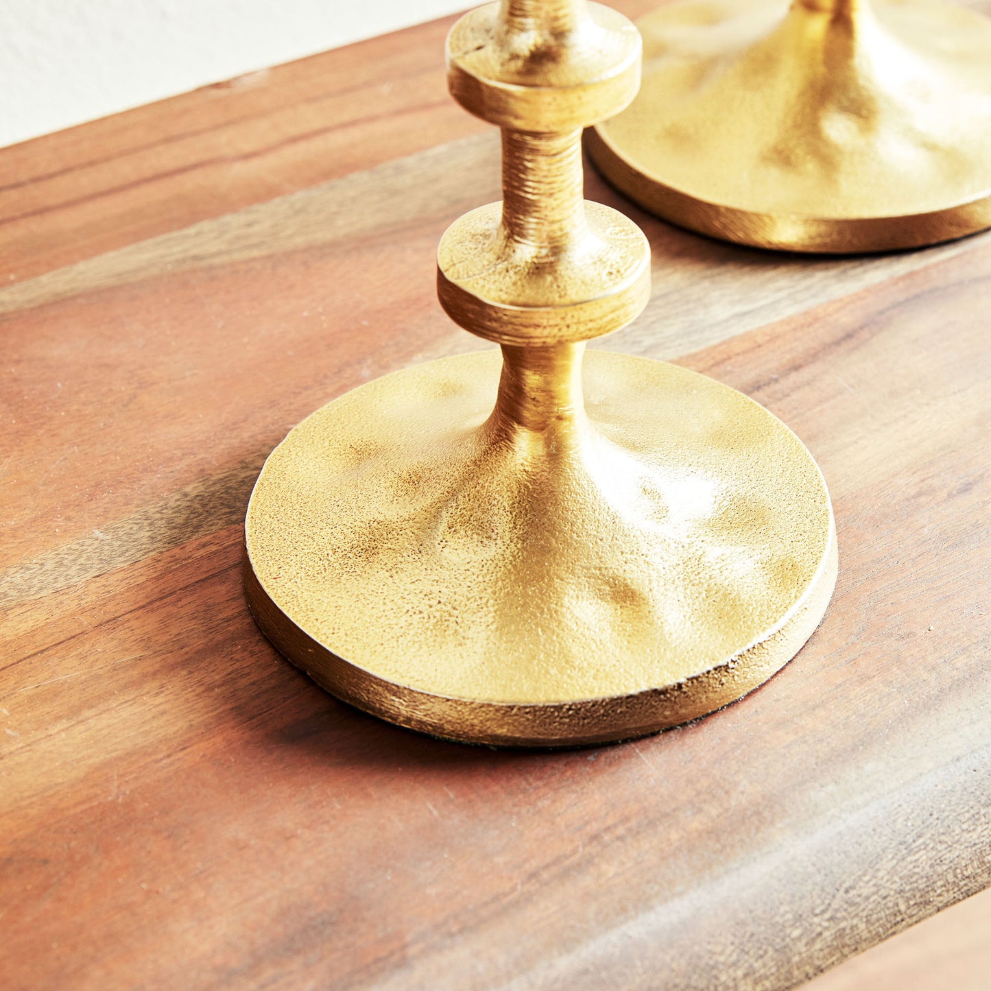 Petite minimalist pillar candleholders, set of 2, in gold finish, closeup view.