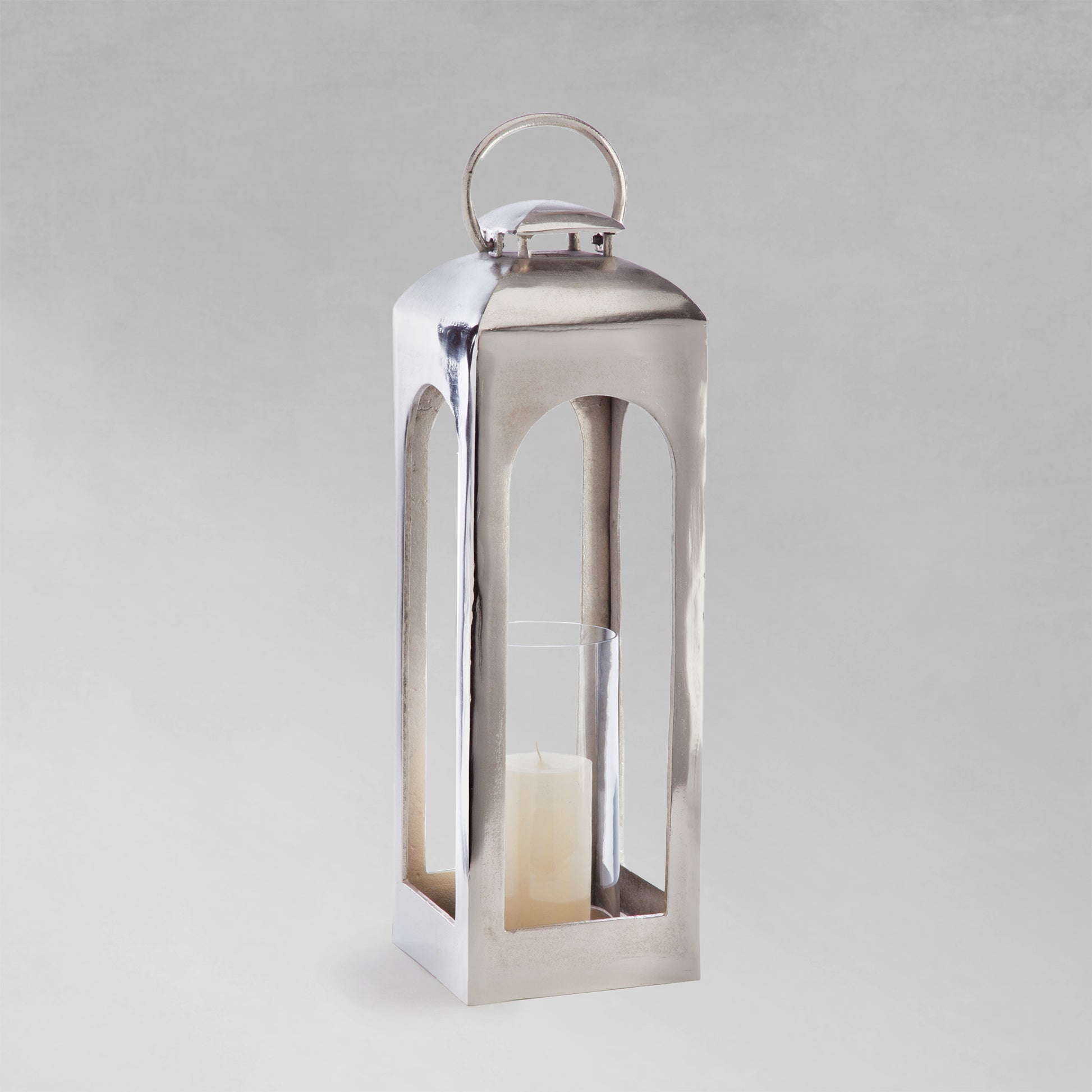 Large polished metal lantern with gray background.