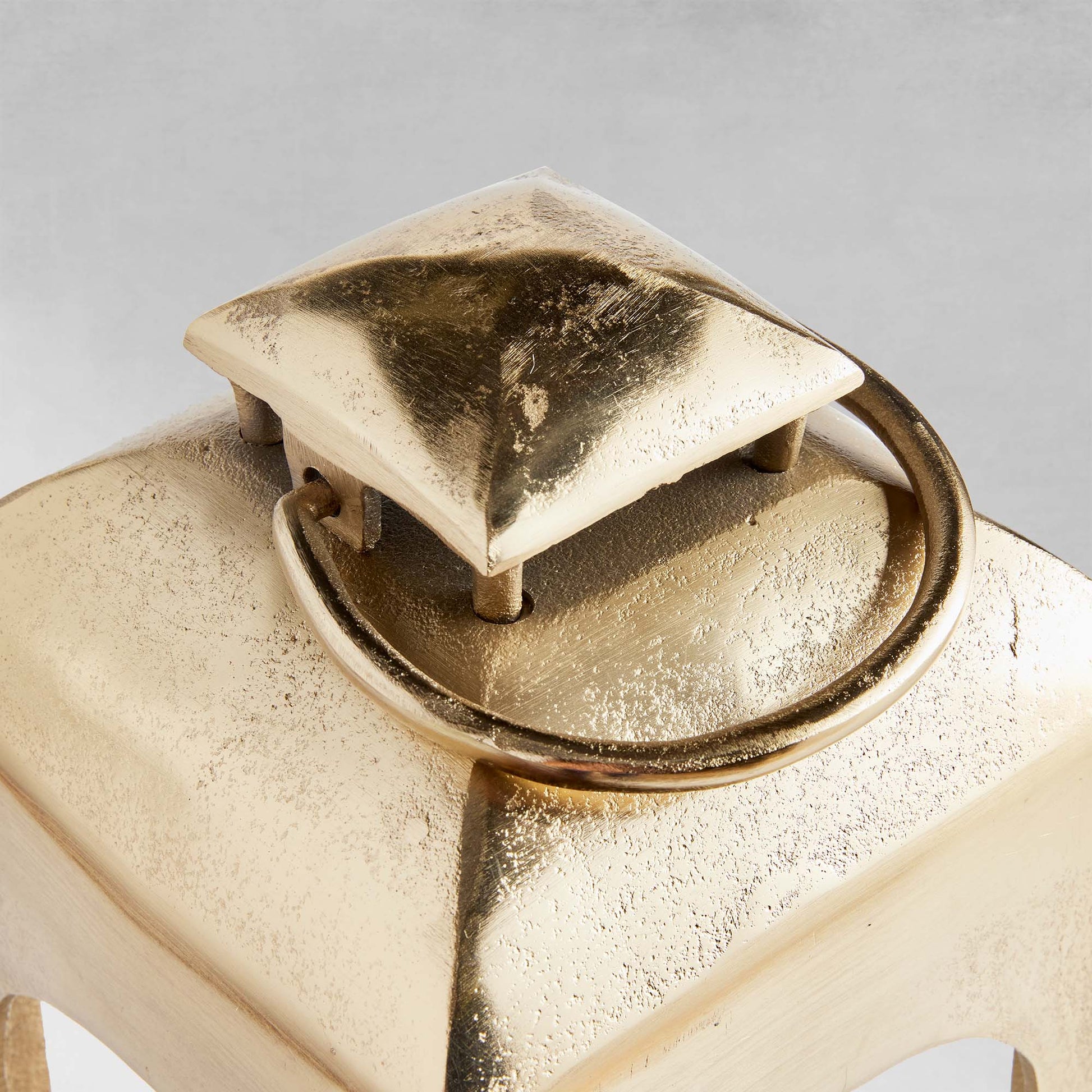 Polished metal lantern with champagne finish, closeup view.