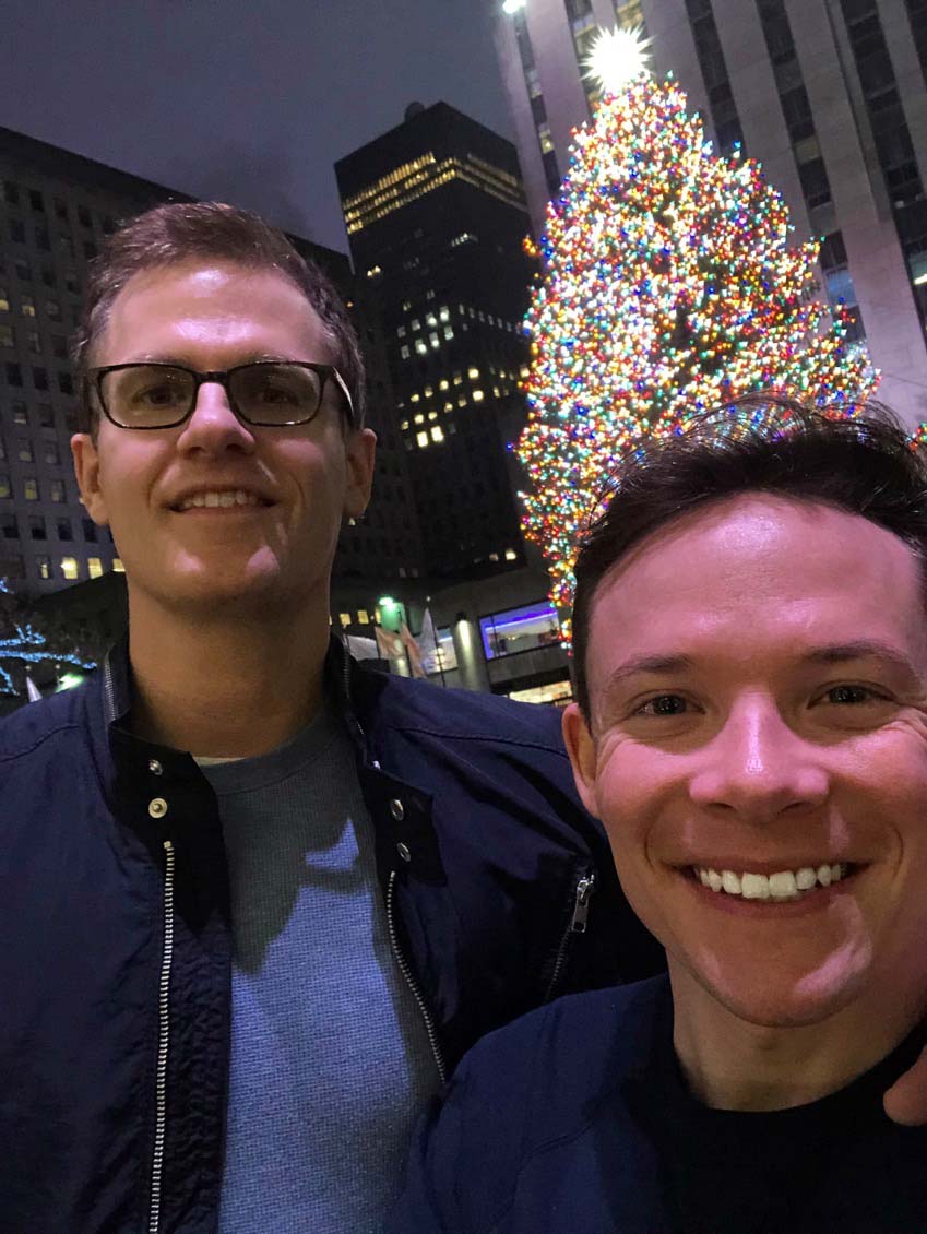 Jeffrey and Adam in New York City in front of the Rockefeller Center Christmas tree.