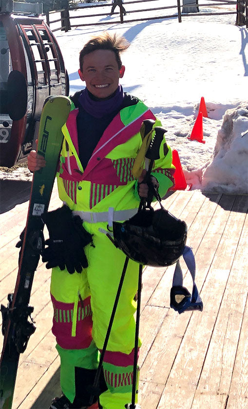 Adam in ski suit holding skis in Park City, Utah.