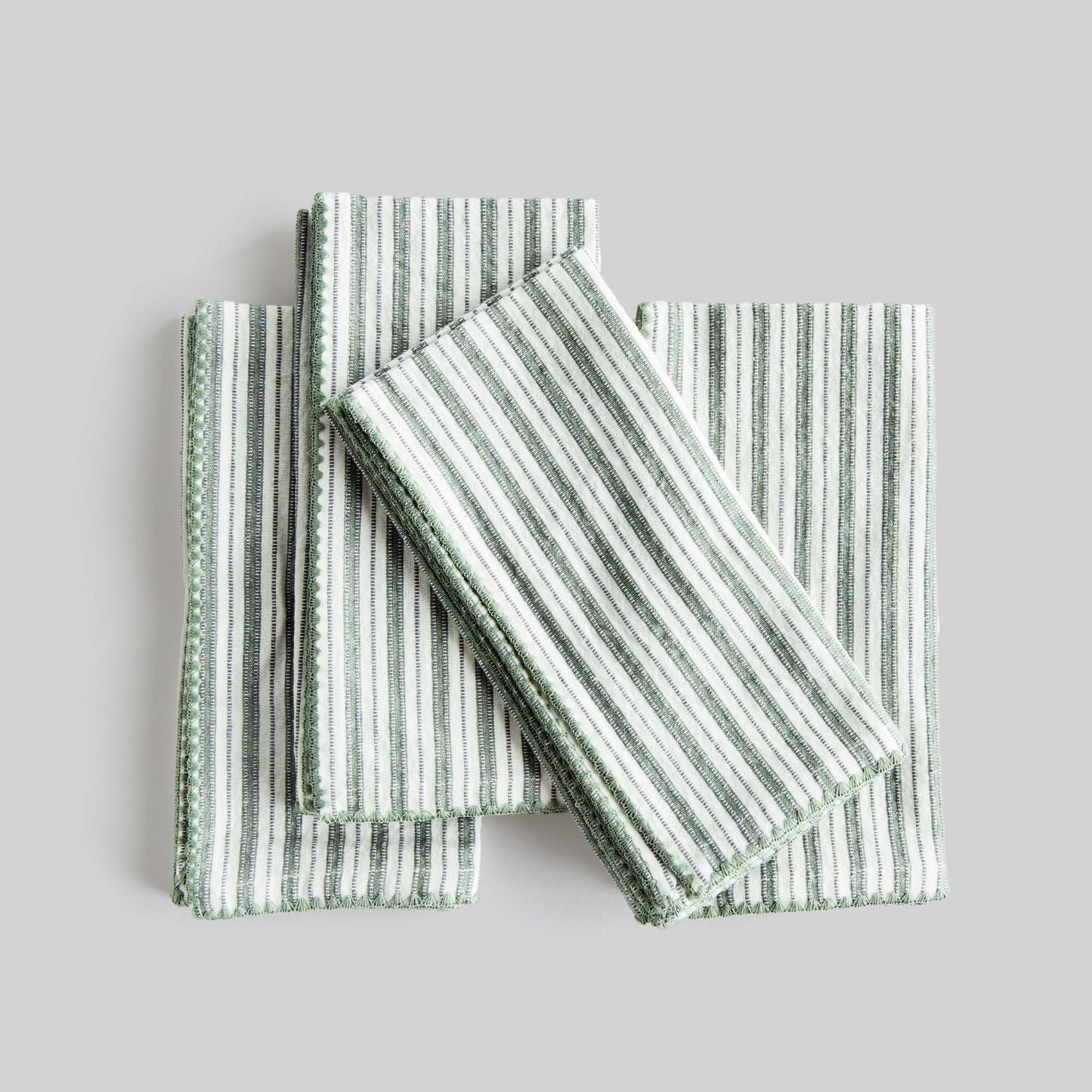 Sage green striped square cotton dinner napkins set of 4 with light gray background.
