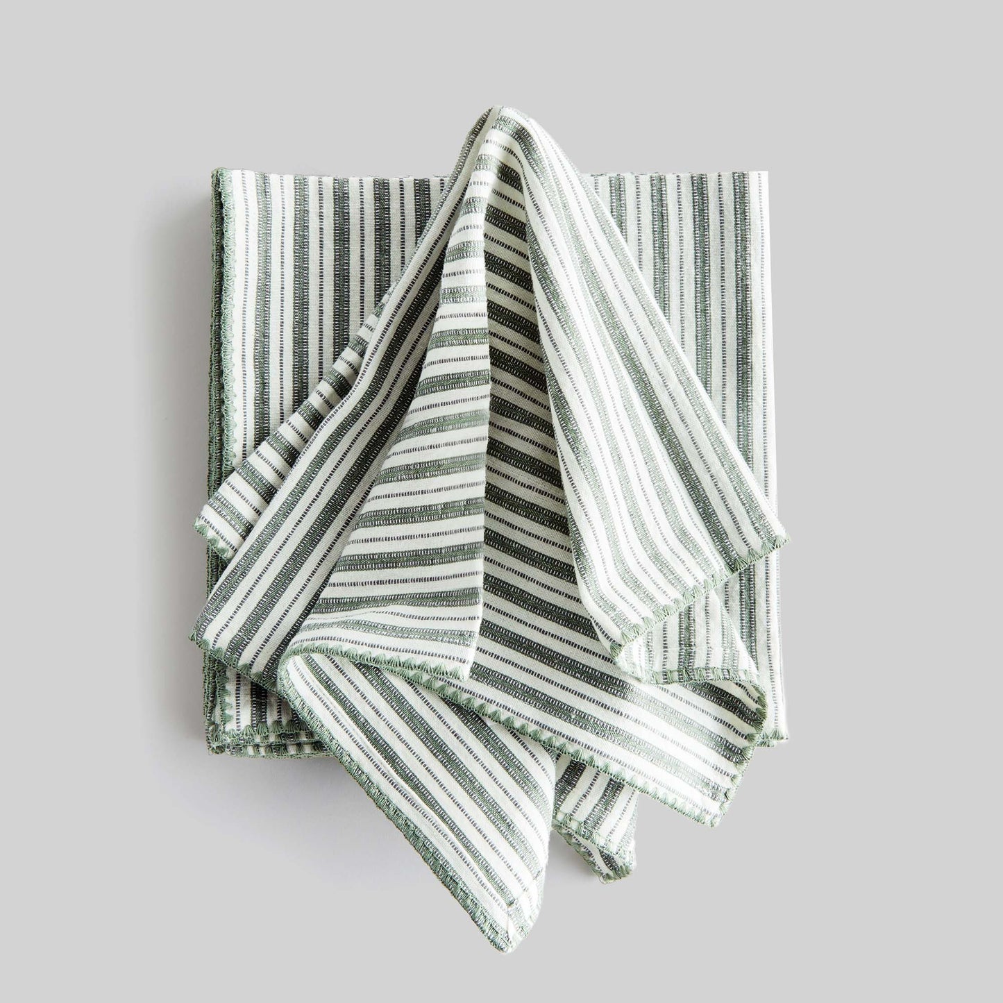 Sage green striped square cotton dinner napkins set of 4 with gray background.