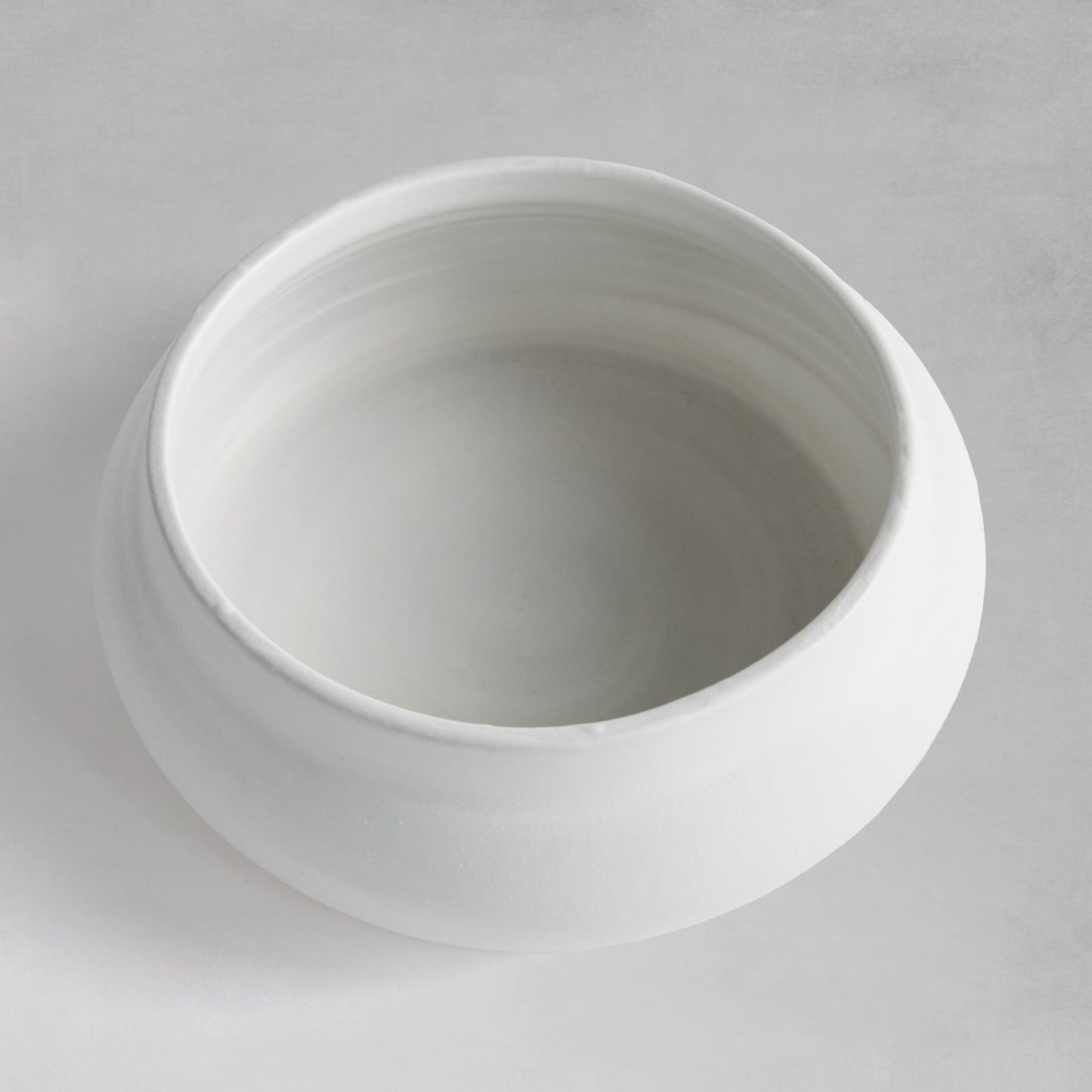 Smooth white decorative terracotta bowl top view.