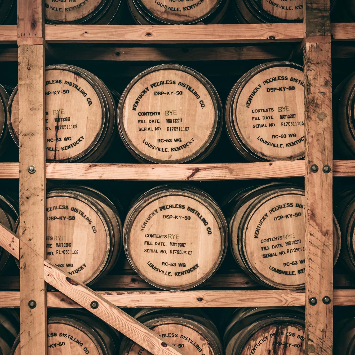 Stacked whiskey and bourbon barrels.