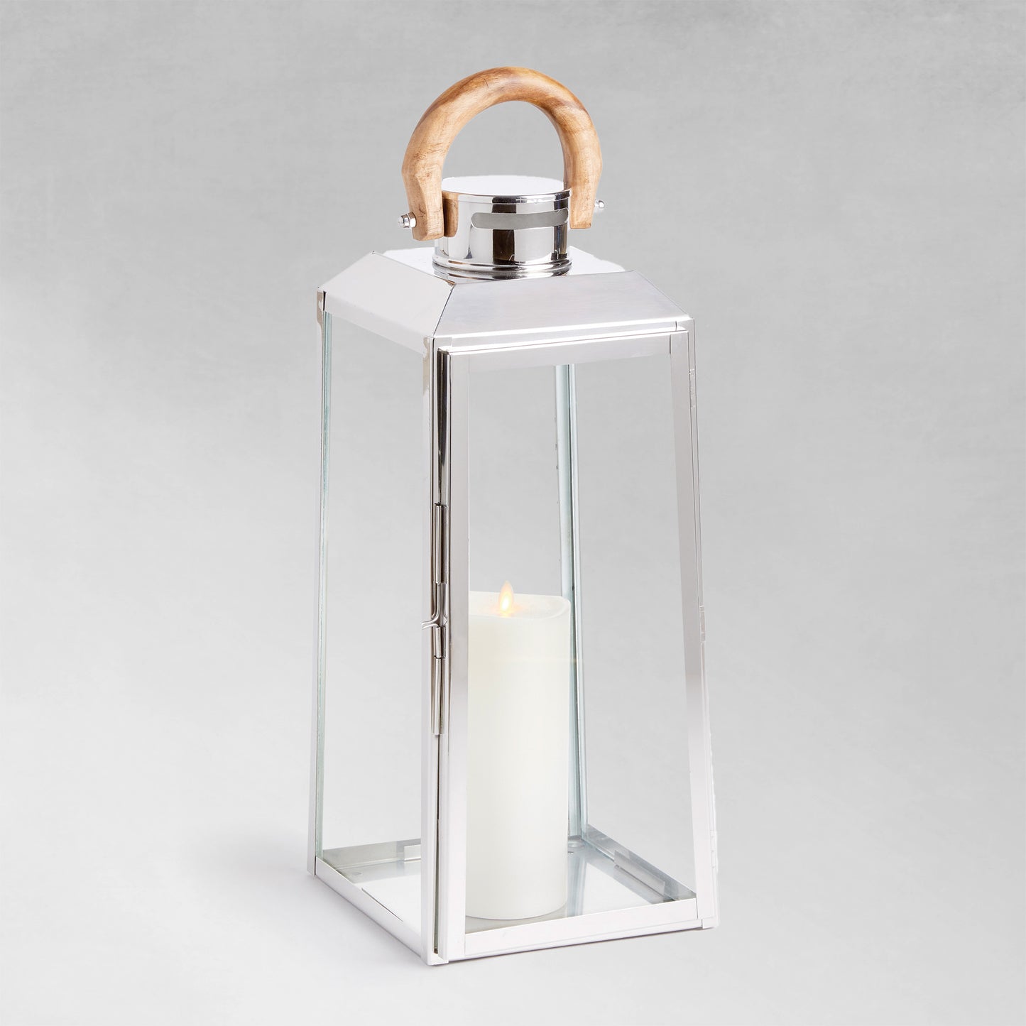 Large stainless steel outdoor lantern with teak wood handle on gray background.