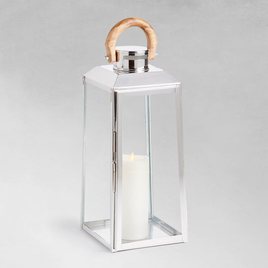 Large stainless steel outdoor lantern with teak wood handle on gray background.