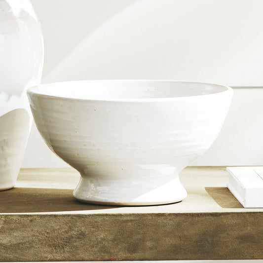 Vintage white terracotta decorative small bowl stylized on console table.