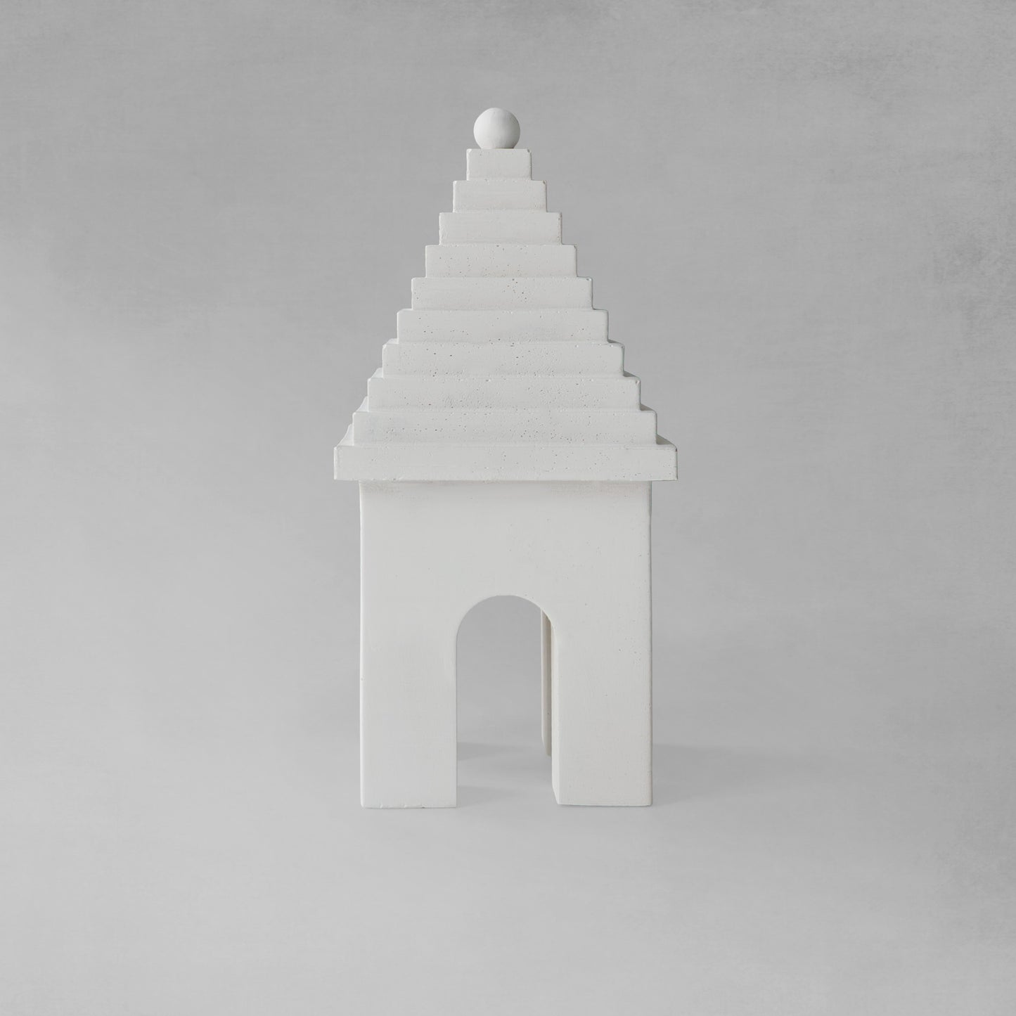 Weathered Bermudian buttery decorative object, front view, with gray background.