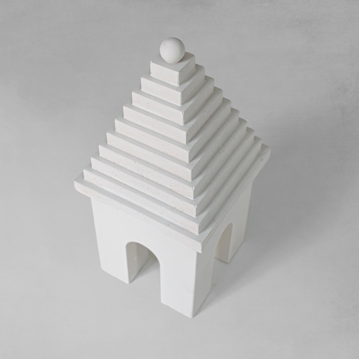 Weathered Bermudian buttery decorative object, top view, with gray background.