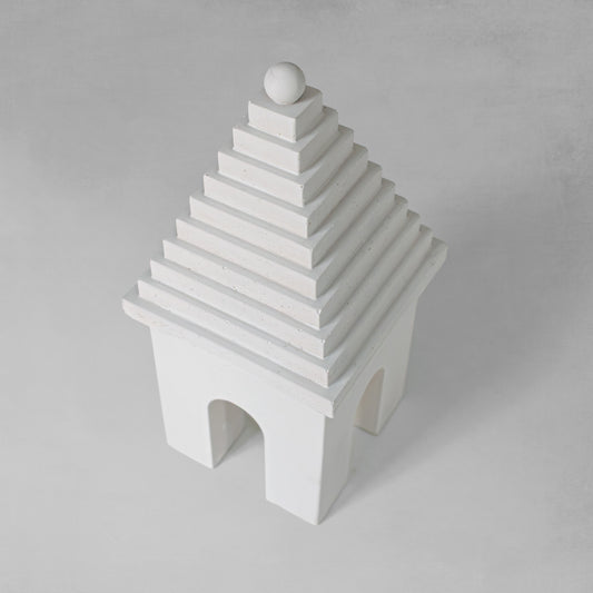 Weathered Bermudian buttery decorative object, top view, with gray background.