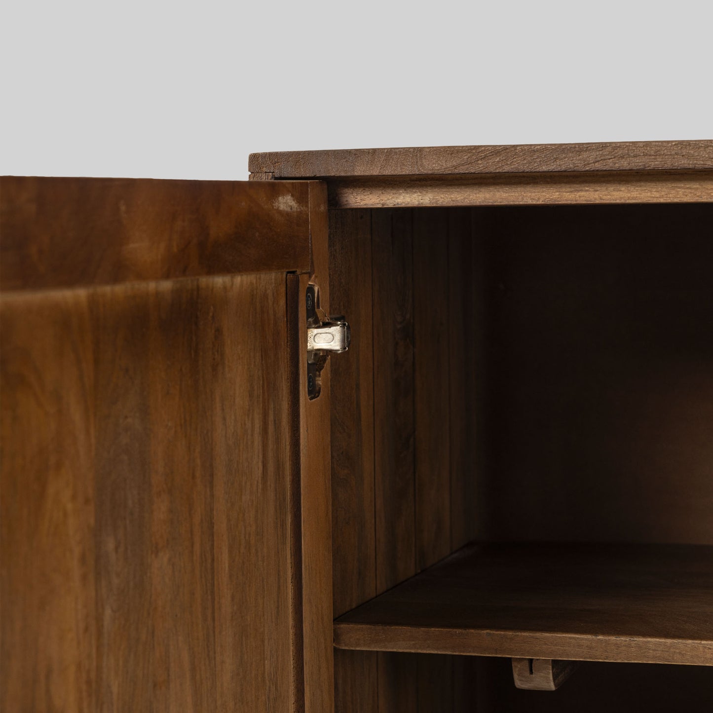 Wood sideboard with geometric pattern on a gray background.