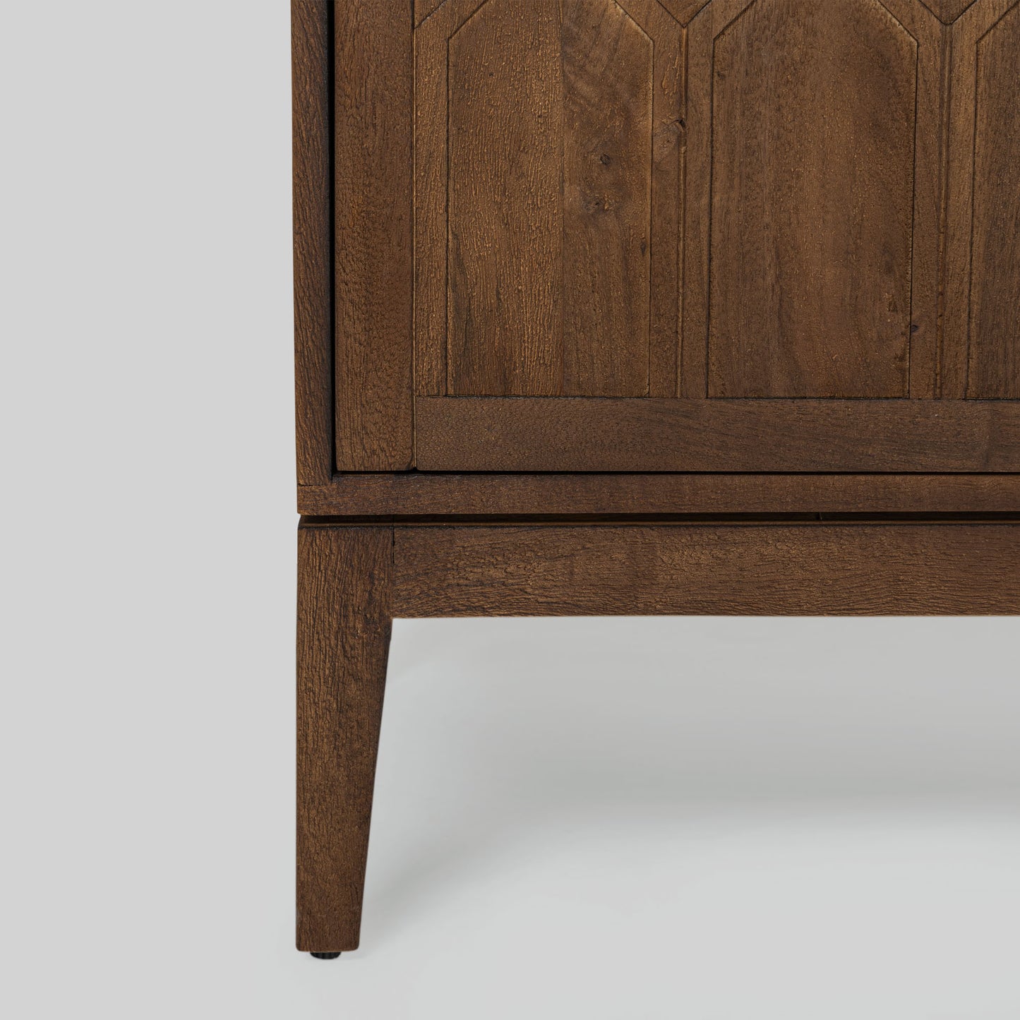 Wood sideboard with geometric pattern on a gray background.