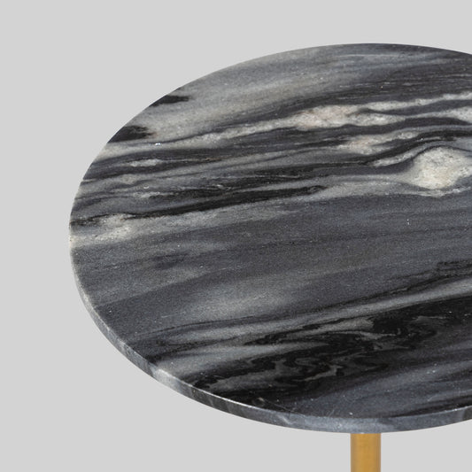 Small round cocktail table with marble top and brass base on a light gray background.