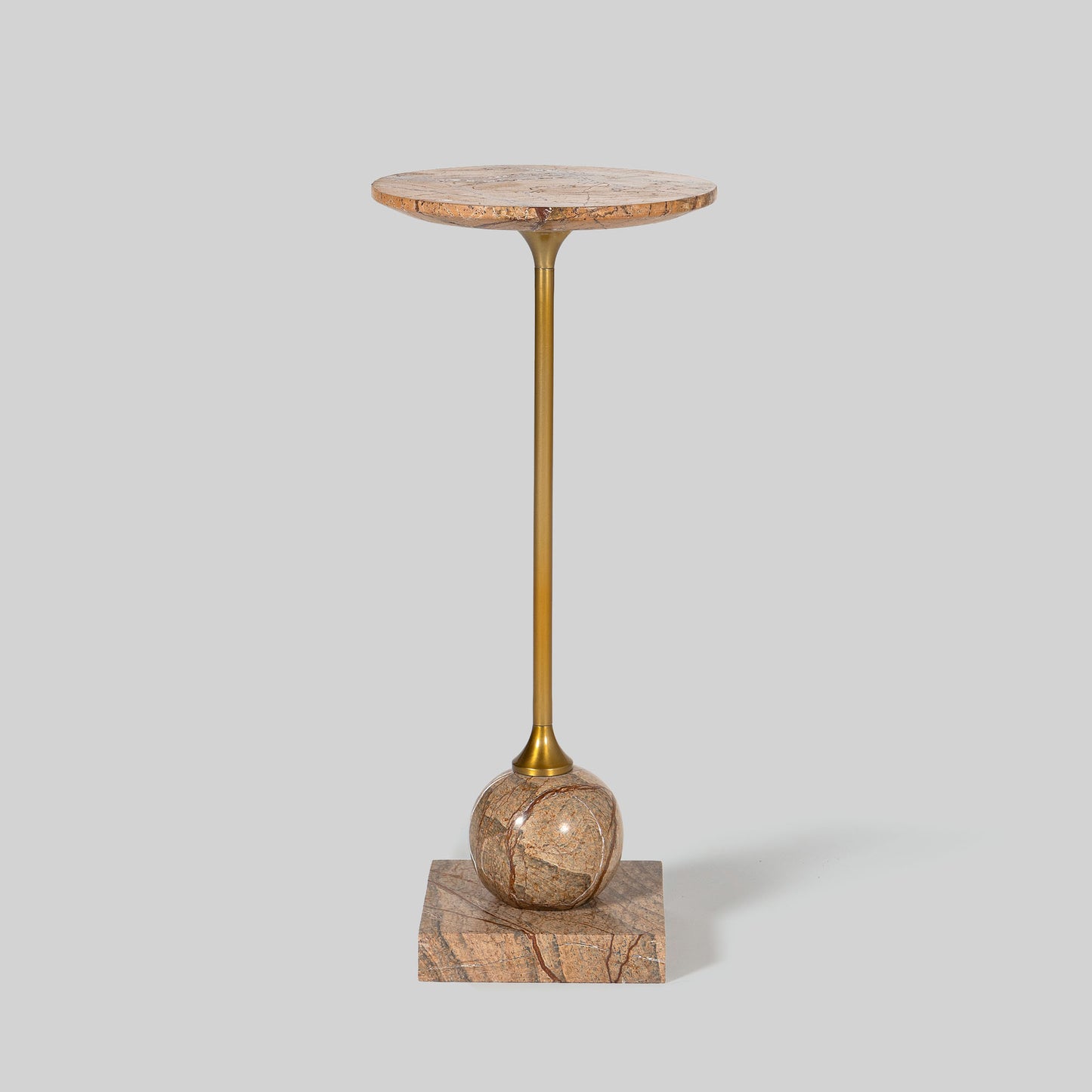 Small round cocktail table with marble top and brass base on a light gray background.
