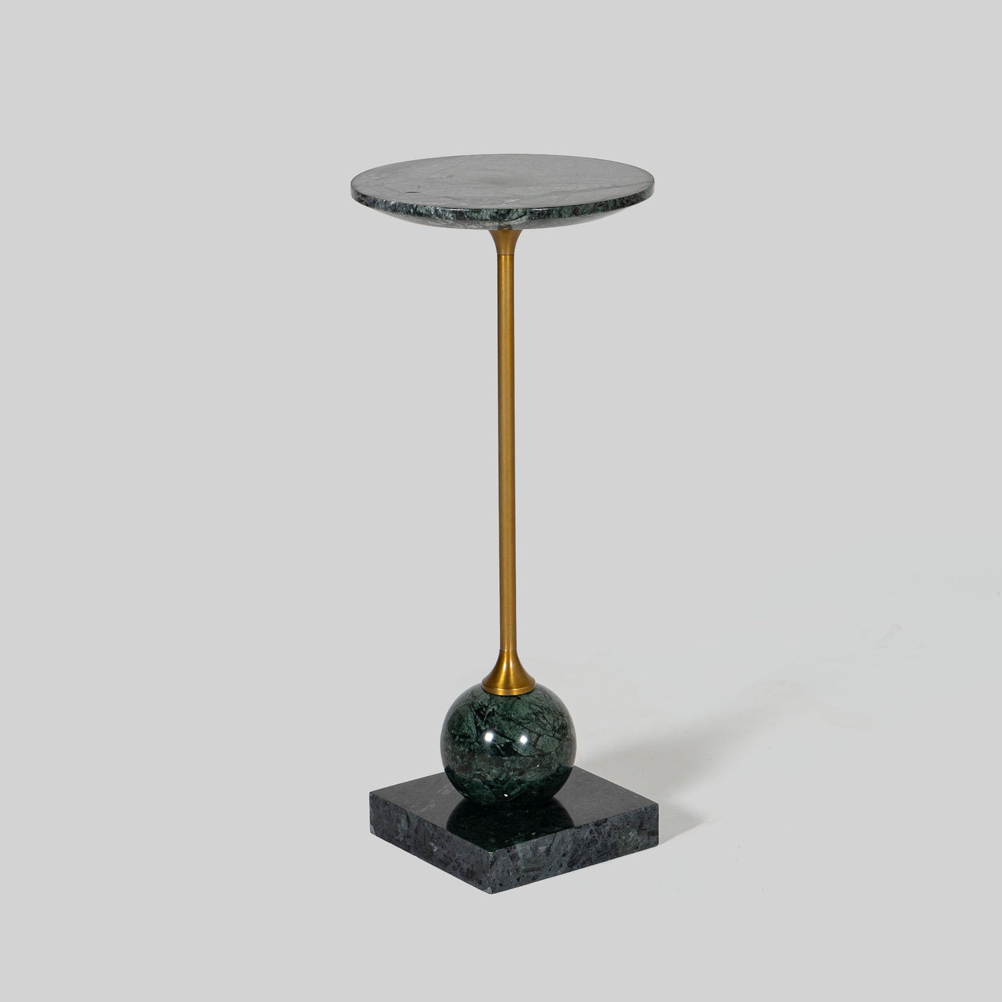 Small round cocktail table with marble top and brass base on a light gray background.