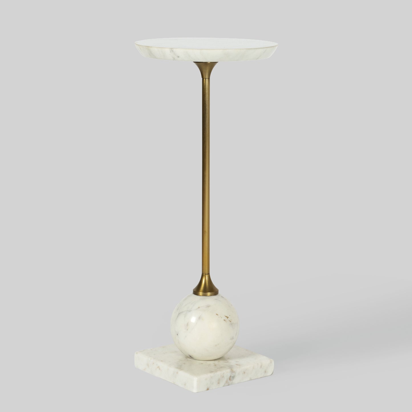 Small round cocktail table with marble top and base on a gray background.