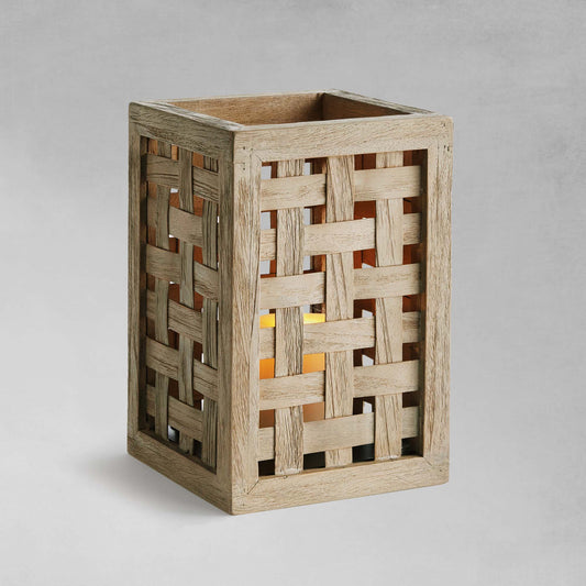 Woven teak hurricane candleholder with gray background.