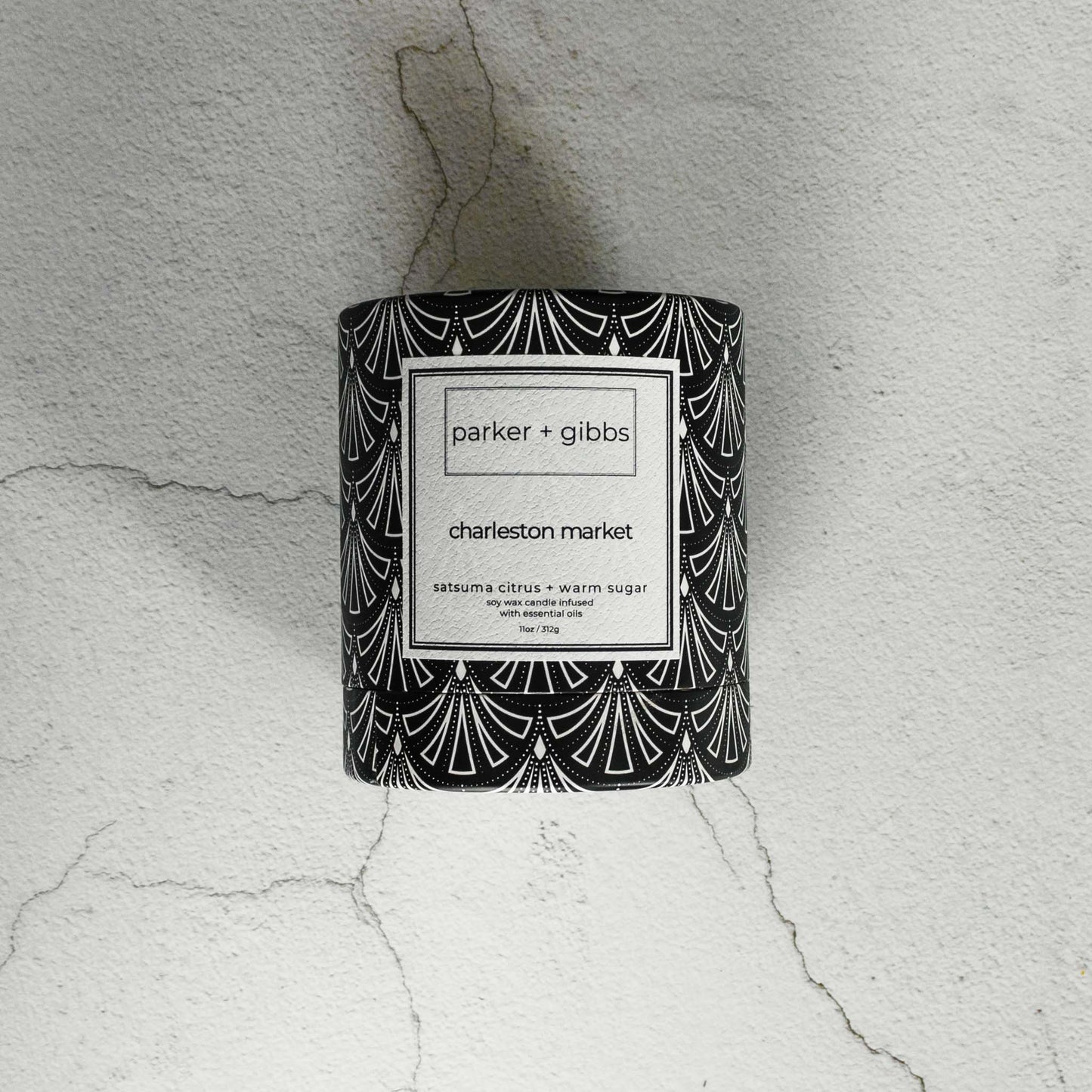 Luxury scented soy wax blend candle box on limestone table.
