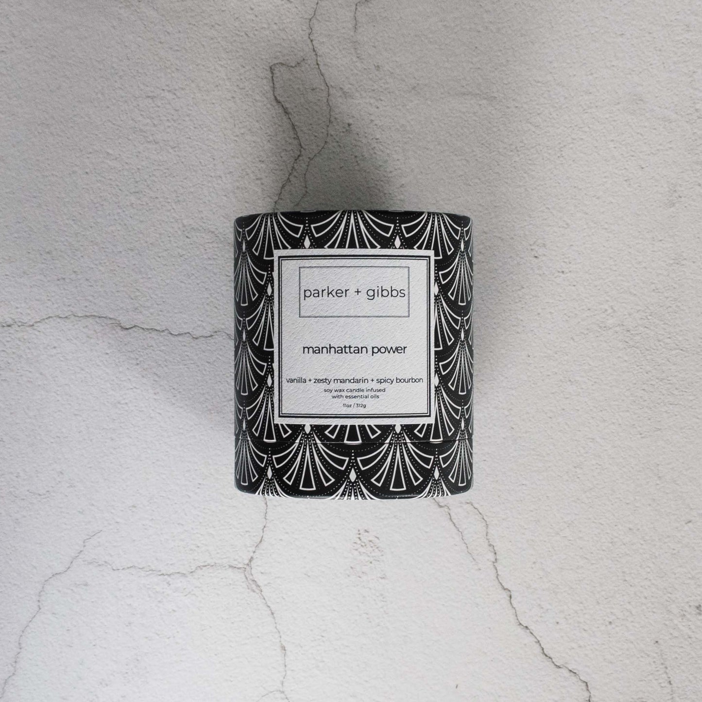 Luxury scented soy wax blend Manhattan Power candle box on limestone table.