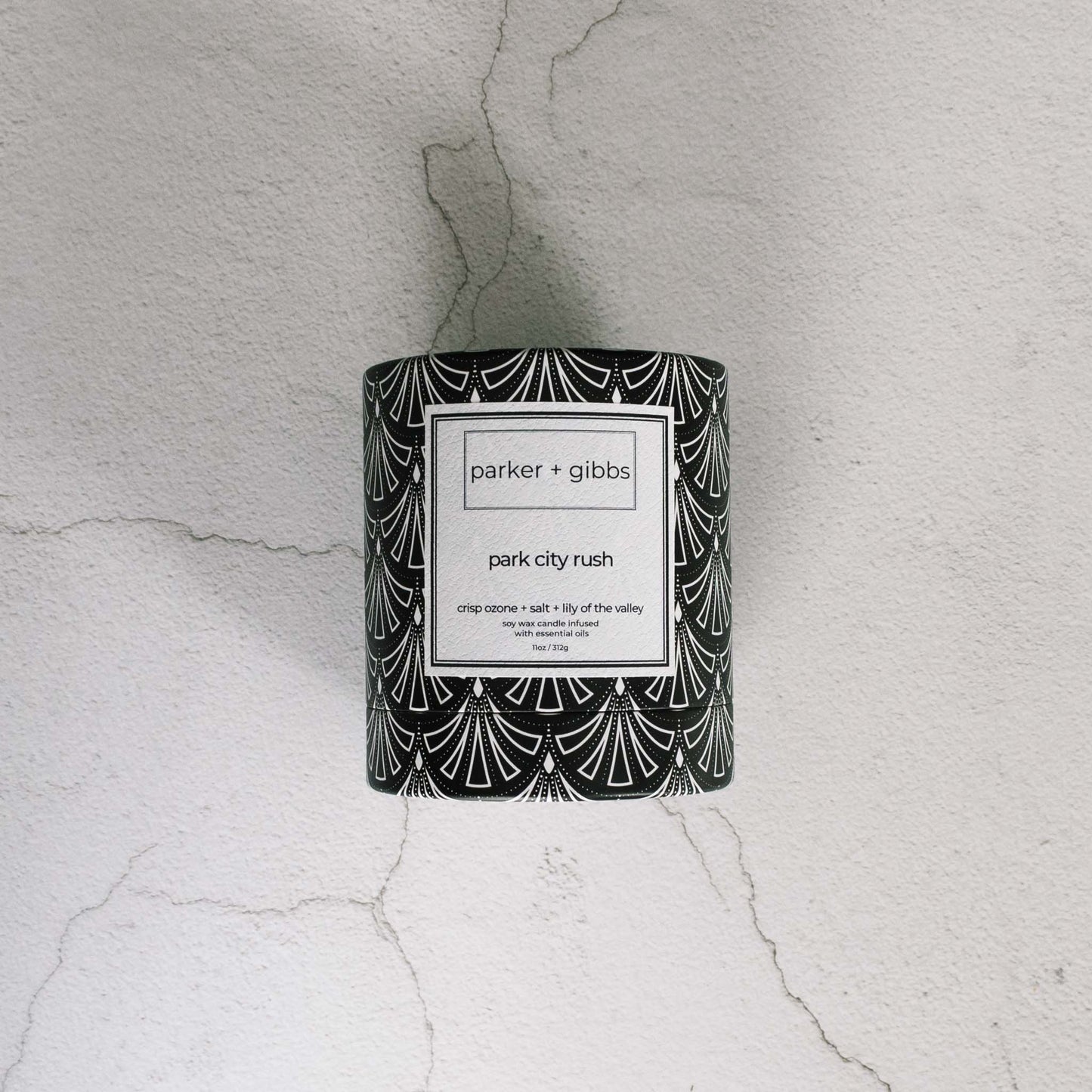 Luxury scented soy wax blend Park City Rush candle box on limestone table.
