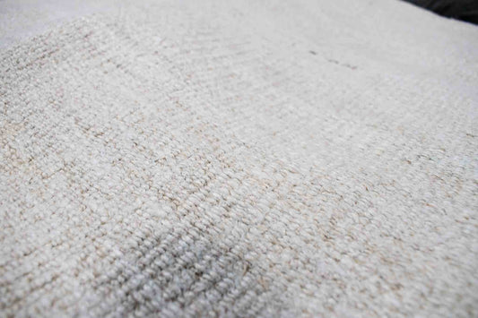 Handwoven Turkish kilim hemp pillow cover fabric in sand with single brown stitch.