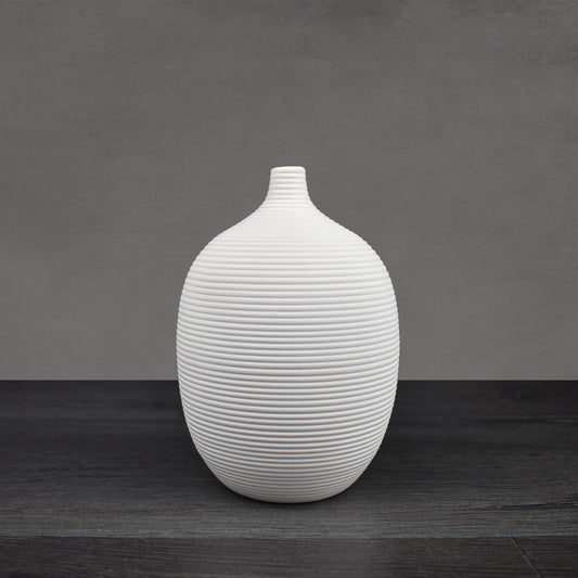 White ceramic ribbed decorative vase.