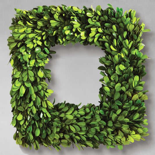 16" square preserved boxwood wreath with gray background.