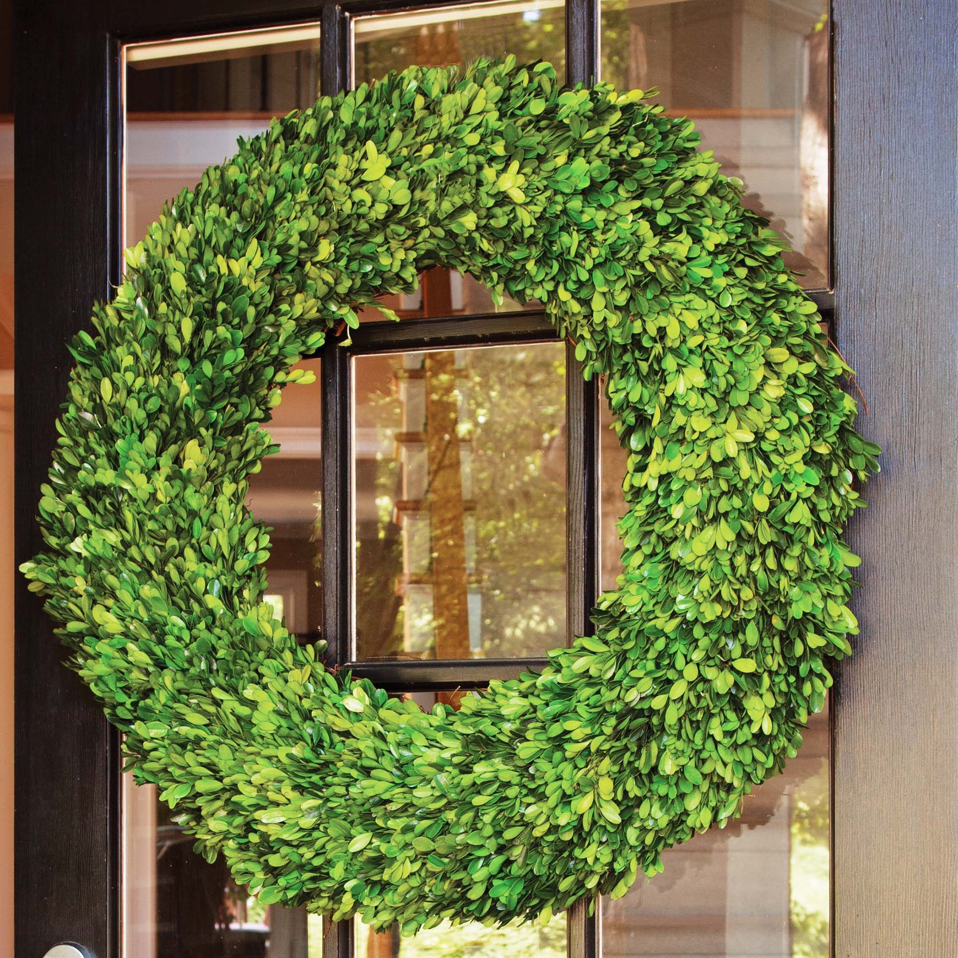 30" round preserved boxwood wreath hung on front door.