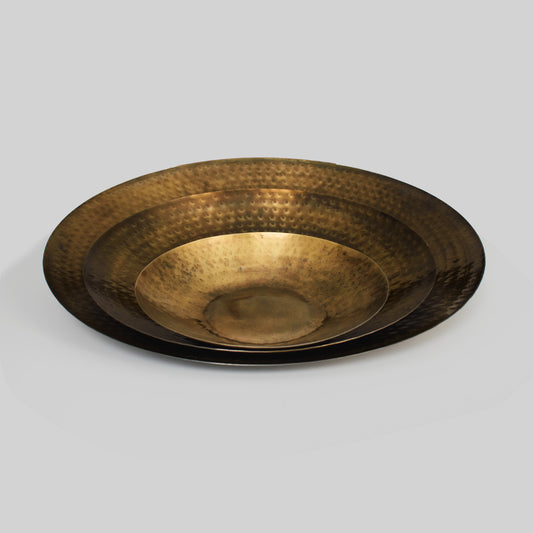 Antique finish brass decorative trays, nested together, with light gray background.