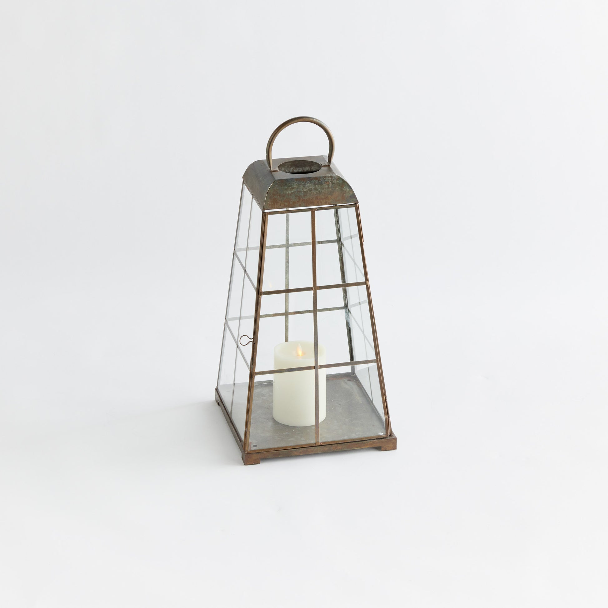 Antique brass metal lantern, small size, with light gray background.