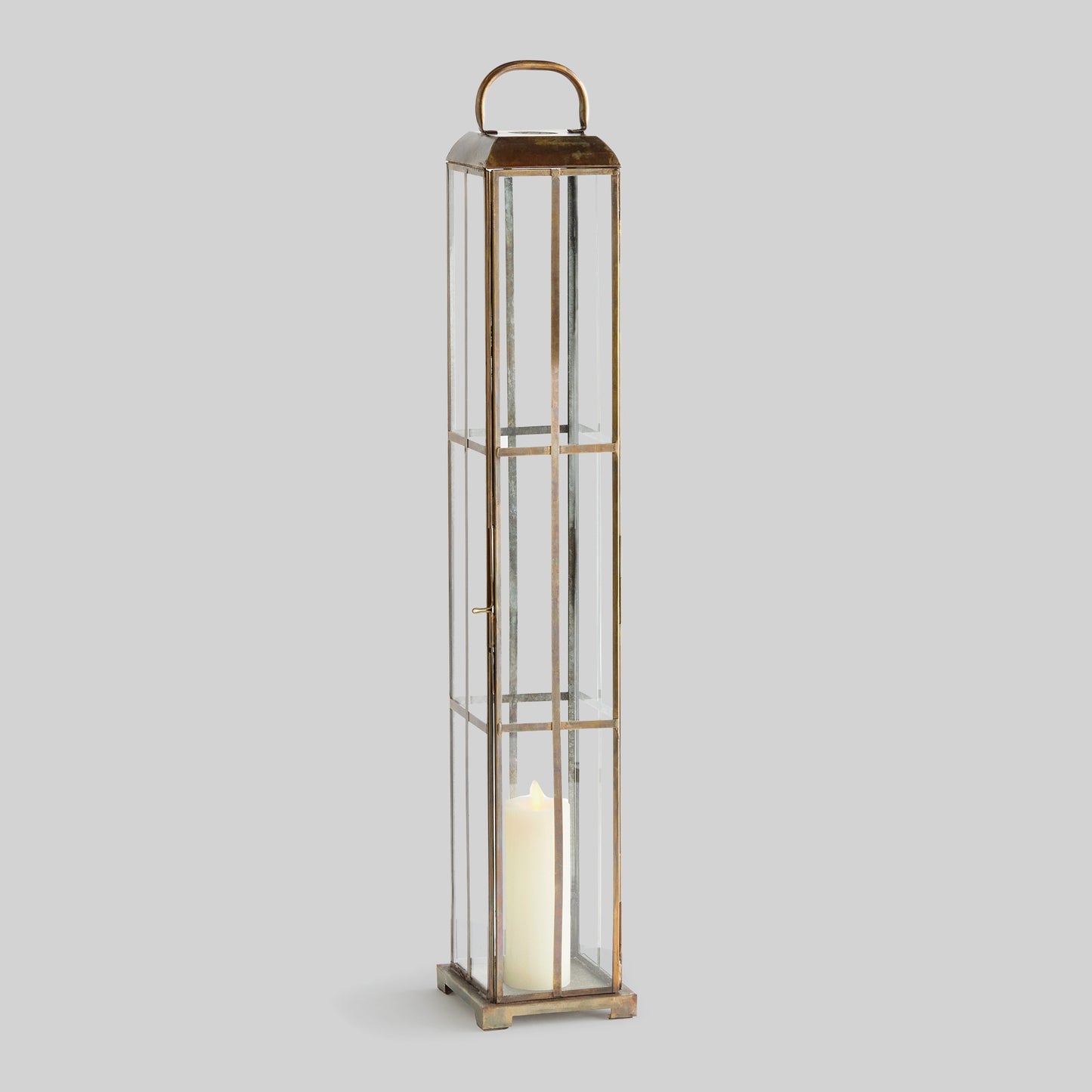 Antique brass tall lantern with gray background.