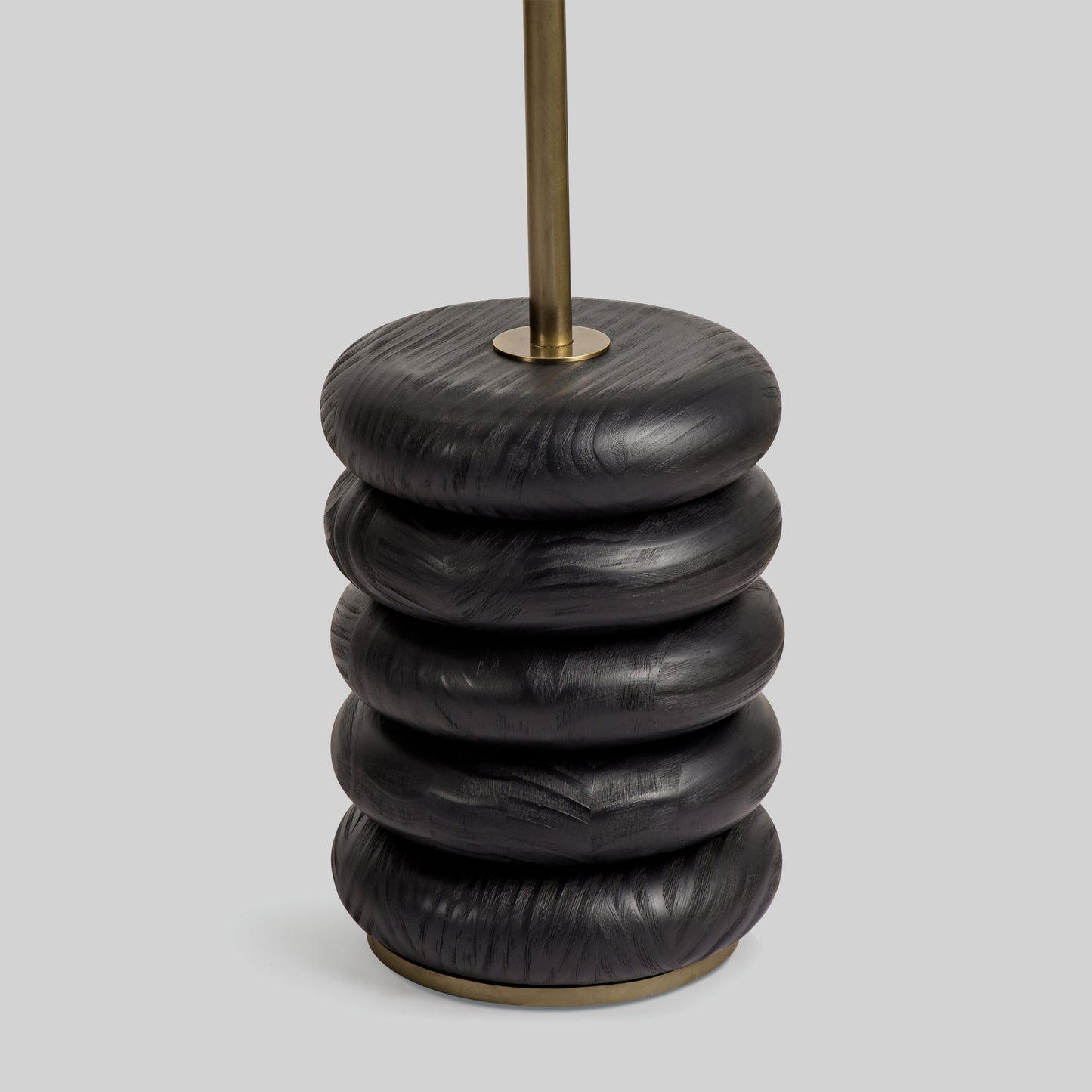 Floor lamp with a curved arm and wooden base on a light gray background.