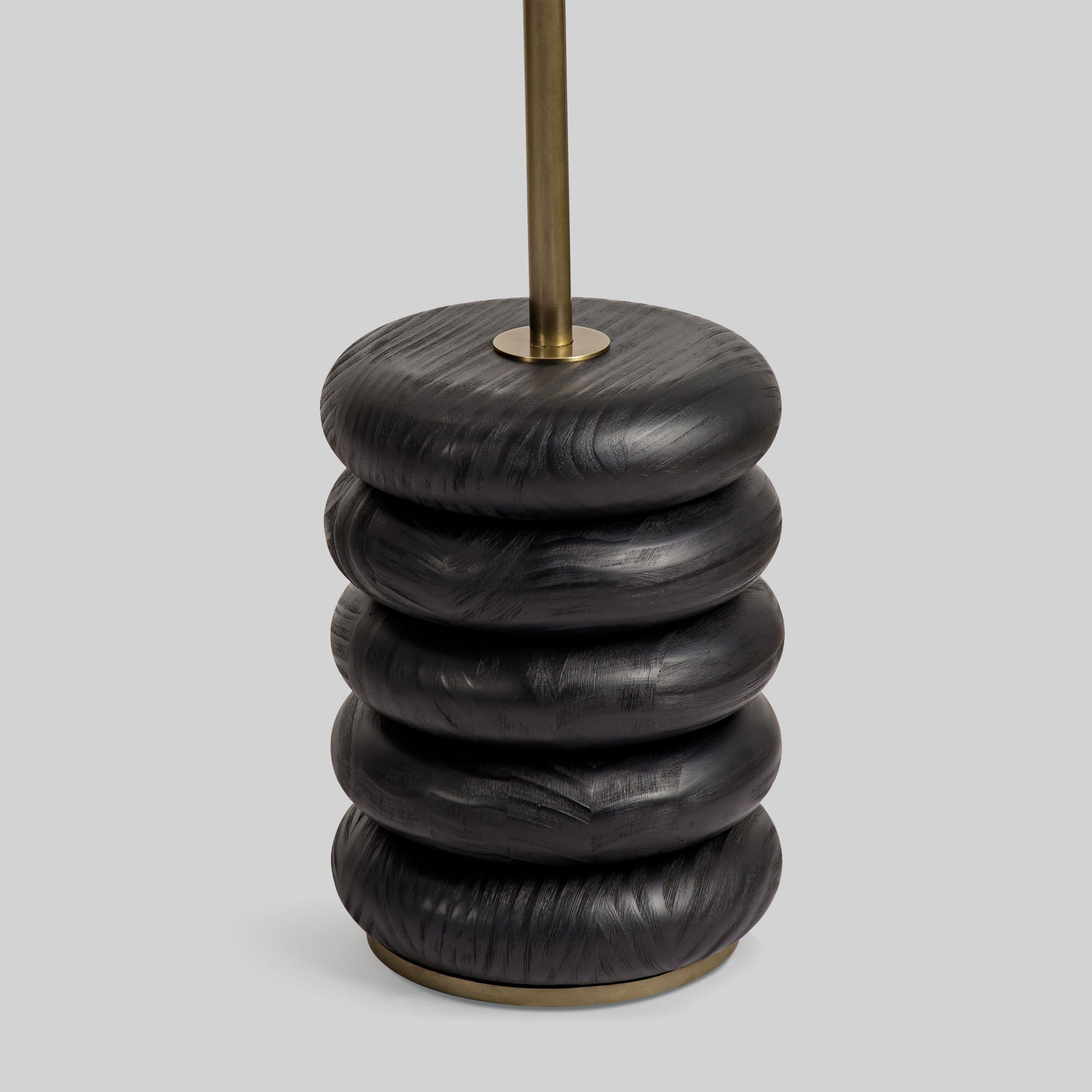 Floor lamp with a curved arm and wooden base on a light gray background.