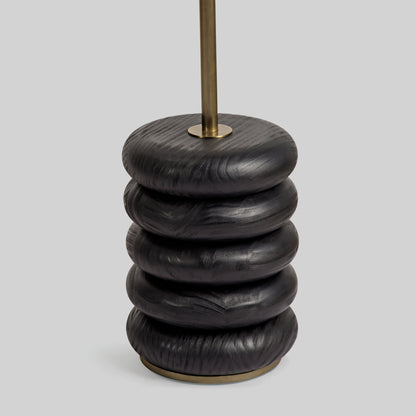 Floor lamp with a curved arm and wooden base on a light gray background.