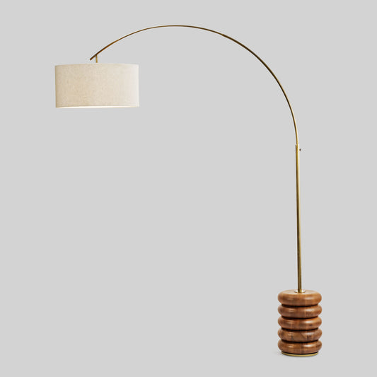 Floor lamp with a curved arm and wooden base on a light gray background.