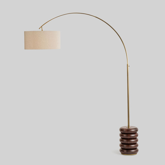 Floor lamp with a curved arm and wooden base on a light gray background.